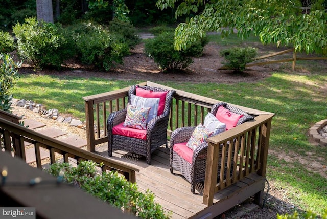 wooden terrace featuring a lawn