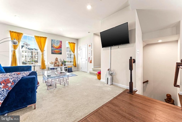 carpeted living area with plenty of natural light, baseboards, and recessed lighting