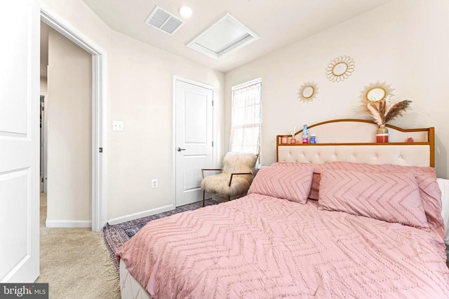 carpeted bedroom with attic access, visible vents, and baseboards