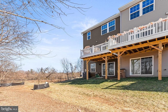 back of property featuring central AC, fence, a lawn, and a wooden deck