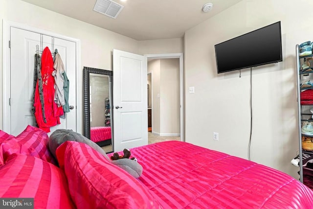 bedroom with a closet and visible vents