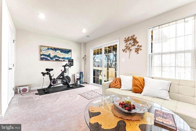 exercise room with carpet floors, visible vents, and baseboards