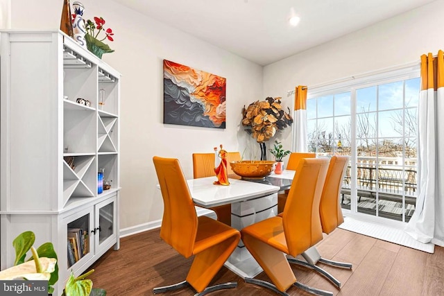 dining area featuring baseboards and wood finished floors