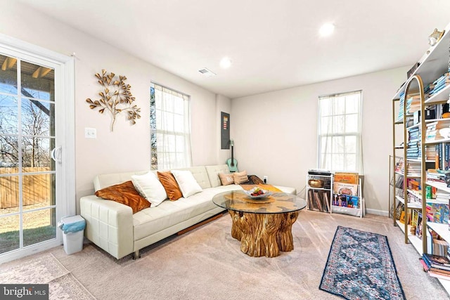 living room with a healthy amount of sunlight, carpet flooring, and recessed lighting