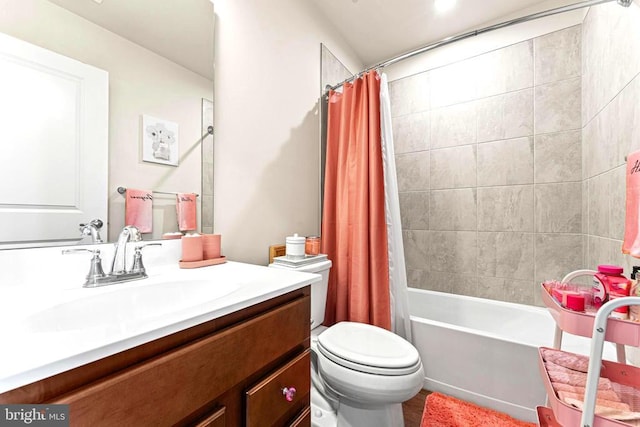 full bathroom featuring toilet, shower / bath combination with curtain, and vanity