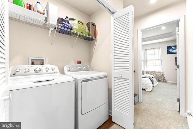 washroom with light carpet, laundry area, and washer and clothes dryer