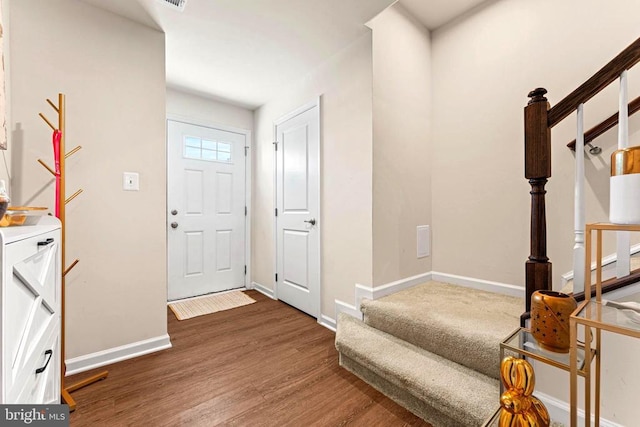 entrance foyer featuring wood finished floors, baseboards, and stairs