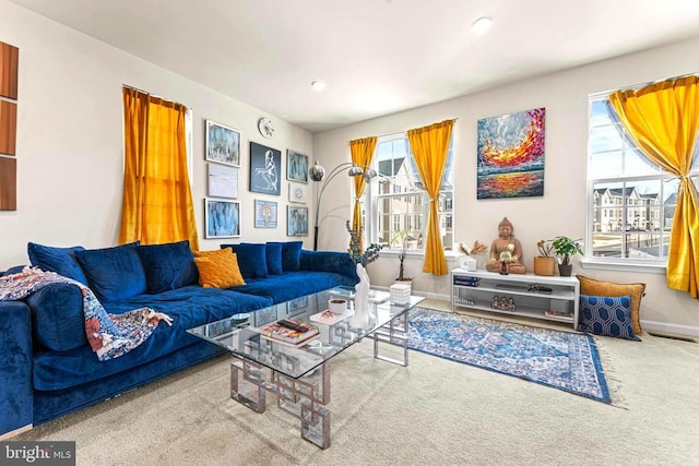 living room featuring carpet and baseboards