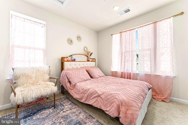 carpeted bedroom with multiple windows, visible vents, and baseboards