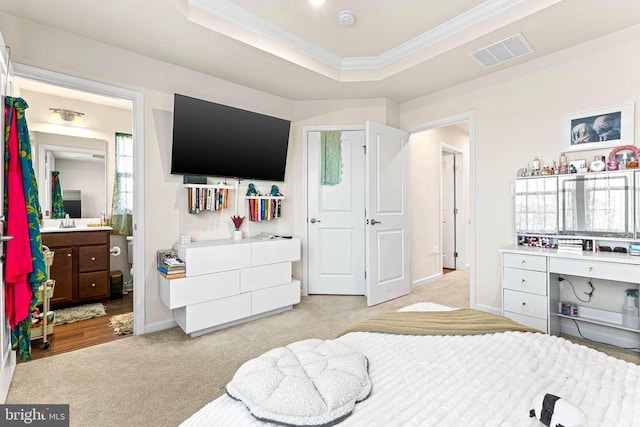 bedroom with ornamental molding, a tray ceiling, visible vents, and carpet