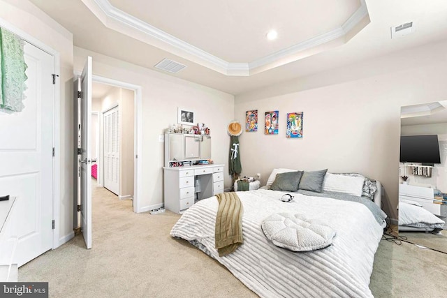 bedroom featuring light carpet, a raised ceiling, visible vents, and crown molding