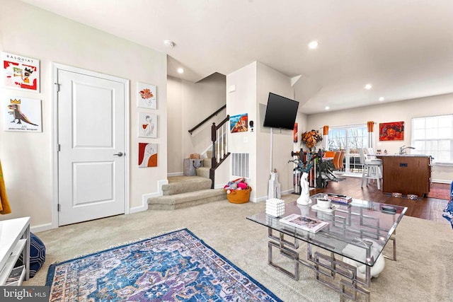 living area with stairway, recessed lighting, visible vents, and baseboards