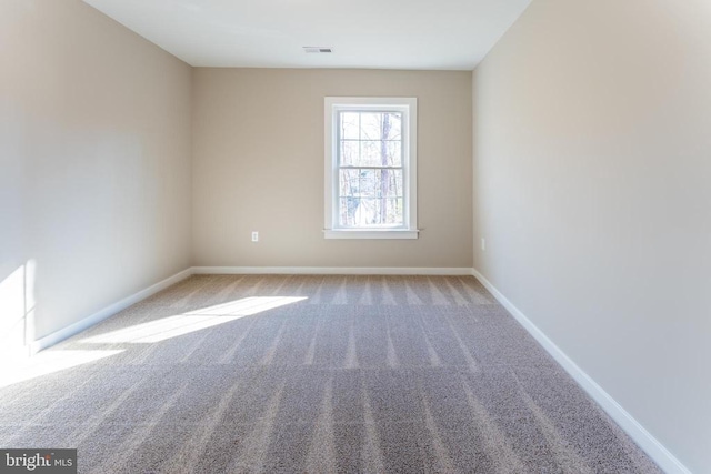 carpeted spare room with baseboards
