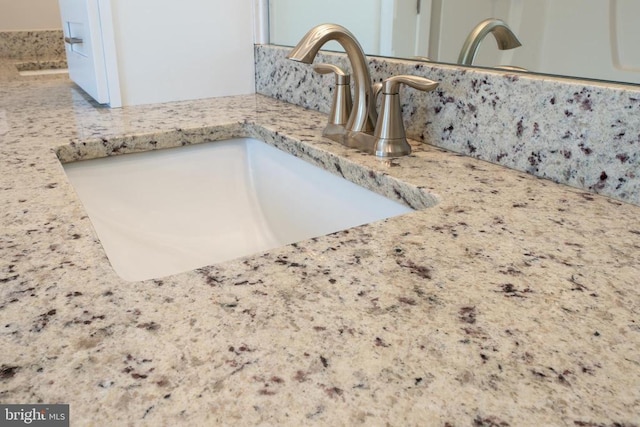 interior details featuring a sink and backsplash