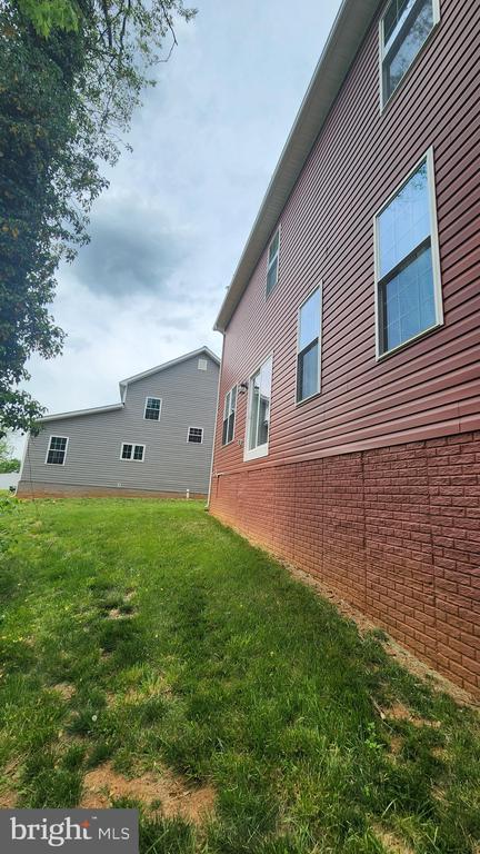 back of property with a yard