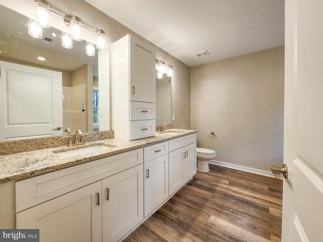 full bath featuring visible vents, wood finished floors, toilet, baseboards, and a sink
