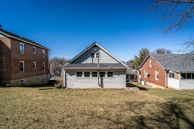 rear view of house featuring a lawn