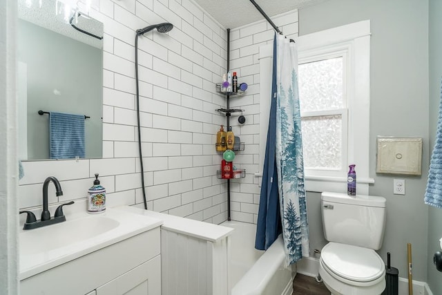 bathroom featuring shower / bath combo, vanity, and toilet