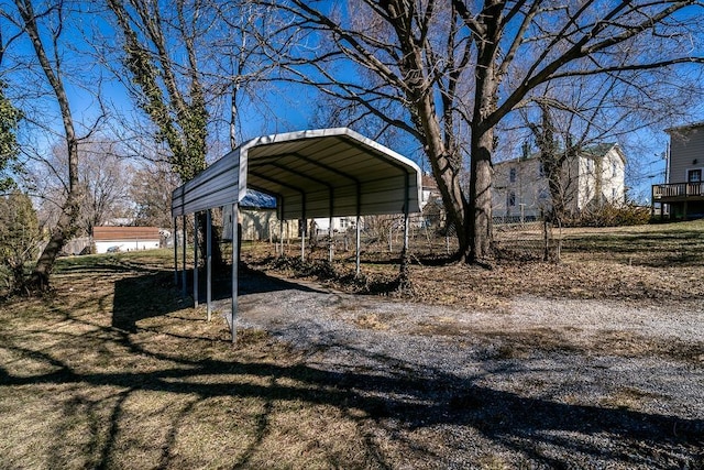 view of yard featuring a detached carport and driveway