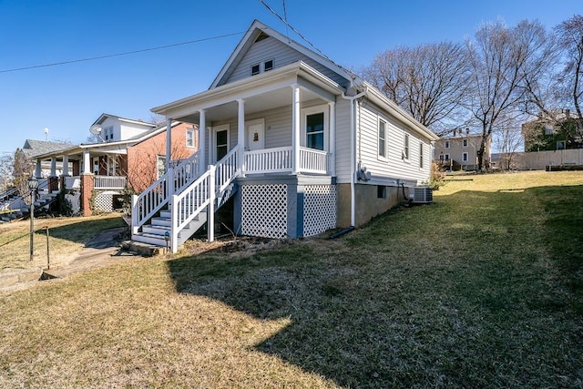 view of front of property with stairway, a front lawn, central AC unit, and a porch