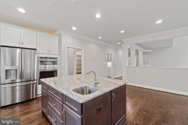 kitchen with dark hardwood / wood-style floors, sink, white cabinets, stainless steel appliances, and a center island with sink