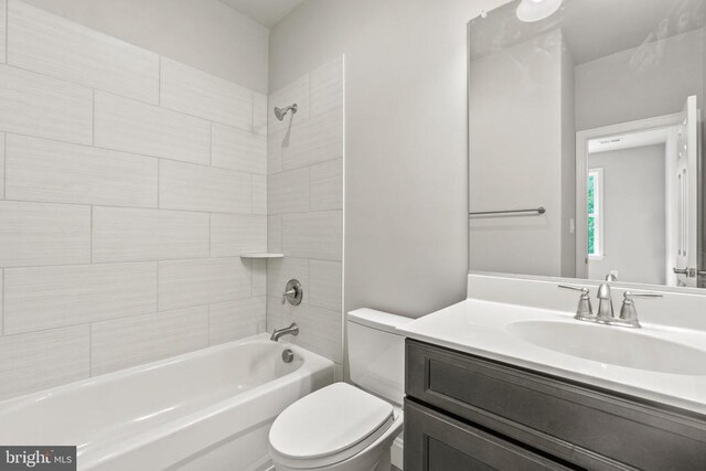 full bathroom with vanity, toilet, and tiled shower / bath combo