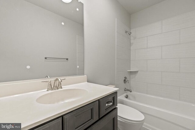 full bathroom with vanity, toilet, and tiled shower / bath