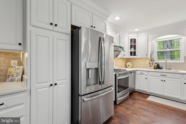 kitchen with white cabinetry, appliances with stainless steel finishes, glass insert cabinets, and tasteful backsplash