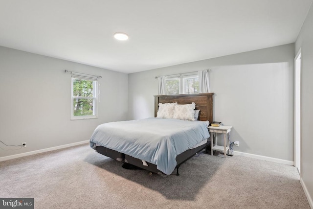 bedroom with baseboards and carpet