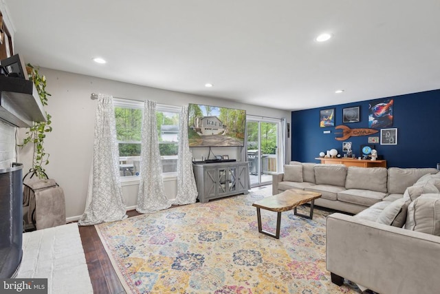 living area featuring wood-type flooring and recessed lighting