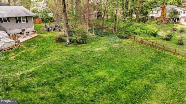 view of yard featuring fence and a deck