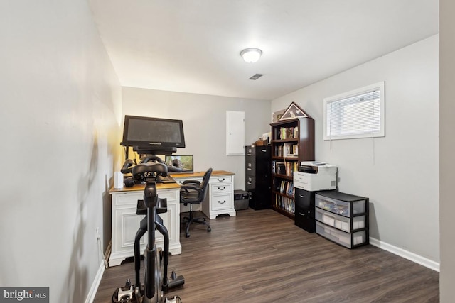 office area with baseboards, visible vents, and dark wood-type flooring