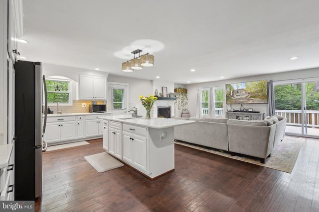 kitchen with a sink, stainless steel appliances, recessed lighting, and open floor plan