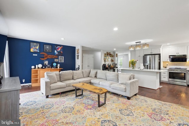 living room featuring recessed lighting and dark wood finished floors