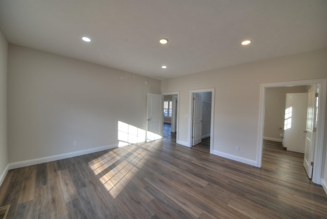 interior space with dark wood-type flooring, recessed lighting, and baseboards