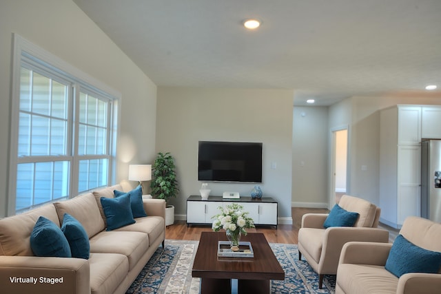 living area featuring baseboards, wood finished floors, and recessed lighting