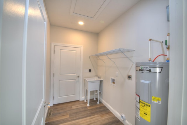 laundry area with hookup for a washing machine, electric water heater, laundry area, wood finished floors, and electric dryer hookup