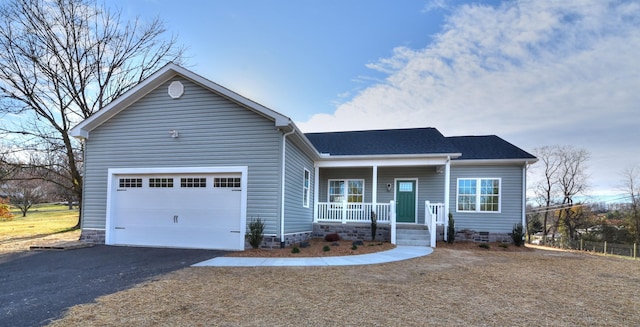 ranch-style home with a porch, crawl space, a garage, and aphalt driveway