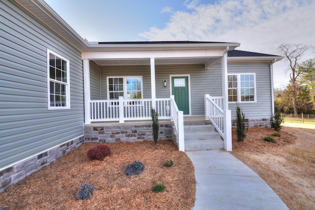 property entrance with crawl space and a porch