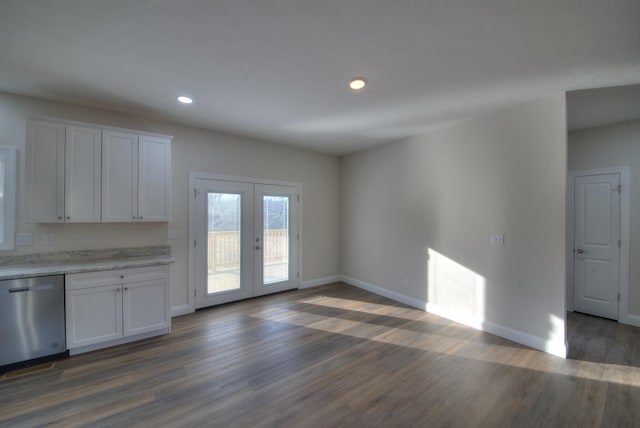 interior space with dark wood-style floors, french doors, light countertops, stainless steel dishwasher, and white cabinets