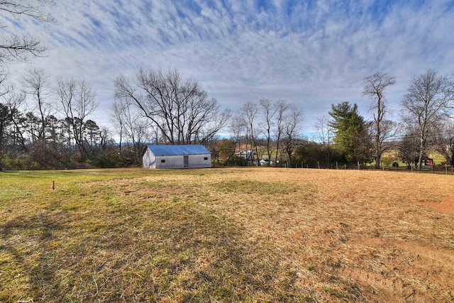 view of yard with a rural view and an outbuilding