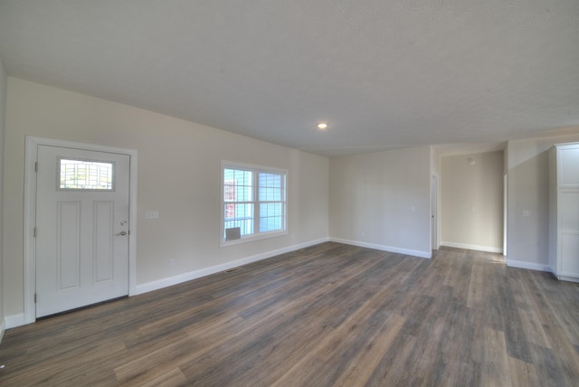 entrance foyer with dark wood finished floors and baseboards