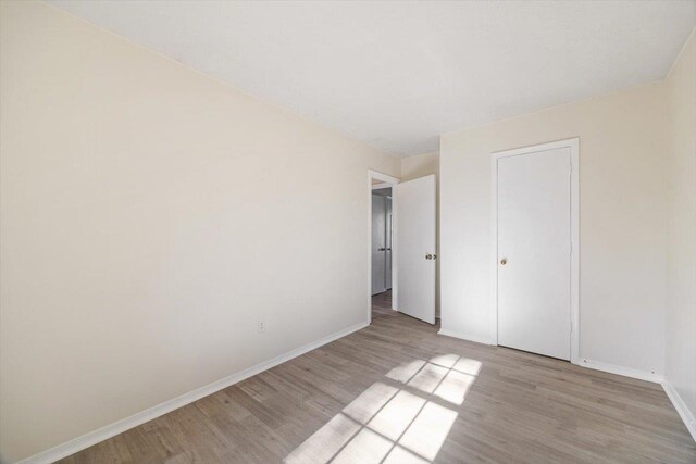 unfurnished bedroom featuring light wood-type flooring