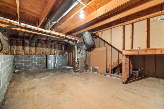 basement with heating unit and electric water heater