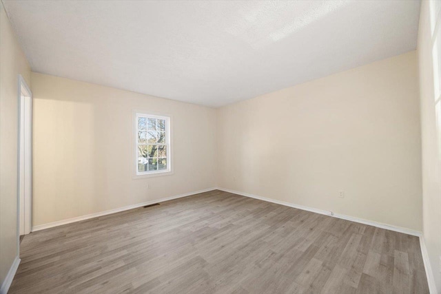 spare room featuring light hardwood / wood-style flooring