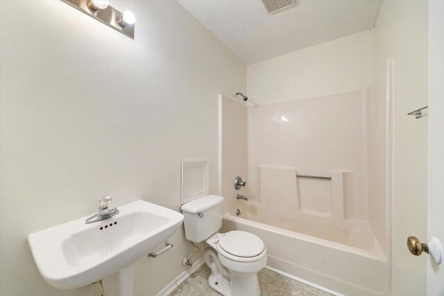 full bathroom featuring tile patterned flooring,  shower combination, sink, and toilet