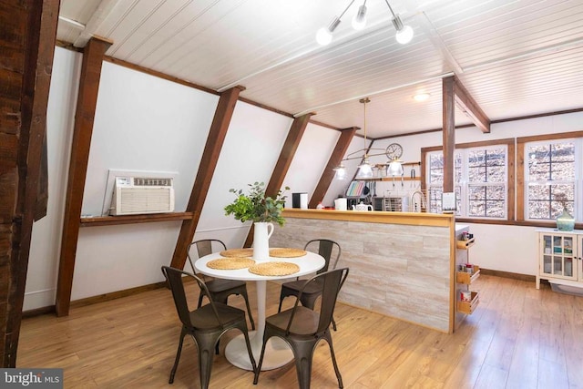 dining space featuring a wall unit AC, light wood-style flooring, wood ceiling, and baseboards