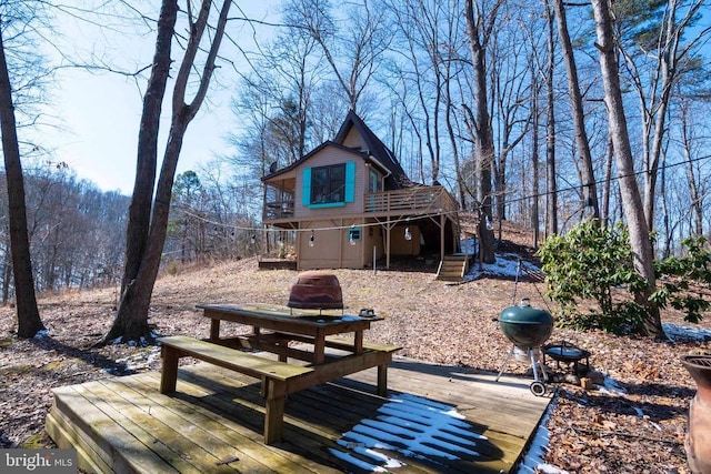 rear view of property featuring a deck