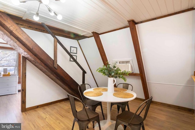 dining room with light wood finished floors, stairway, baseboards, and a wall mounted AC