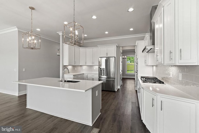 kitchen featuring light countertops, hanging light fixtures, appliances with stainless steel finishes, white cabinetry, and a sink